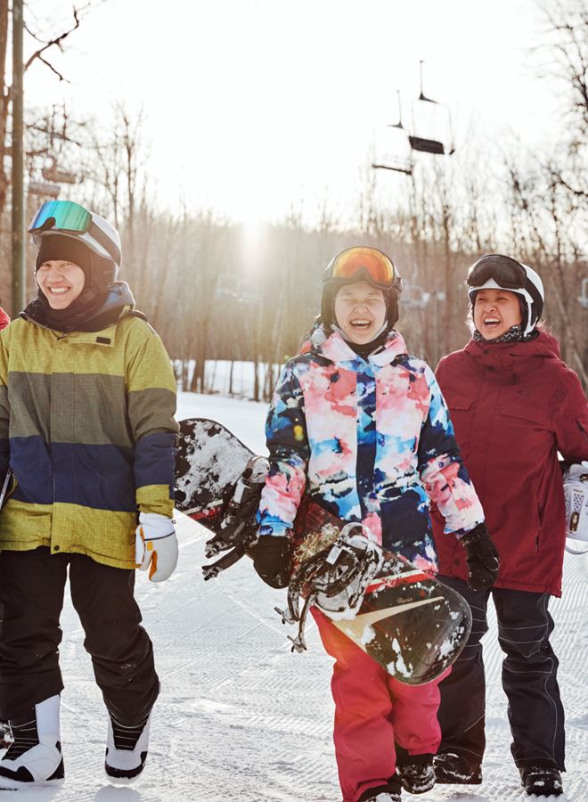 Friends Walk With Snowboards At Granite Peak In Wausau, Wisconsin