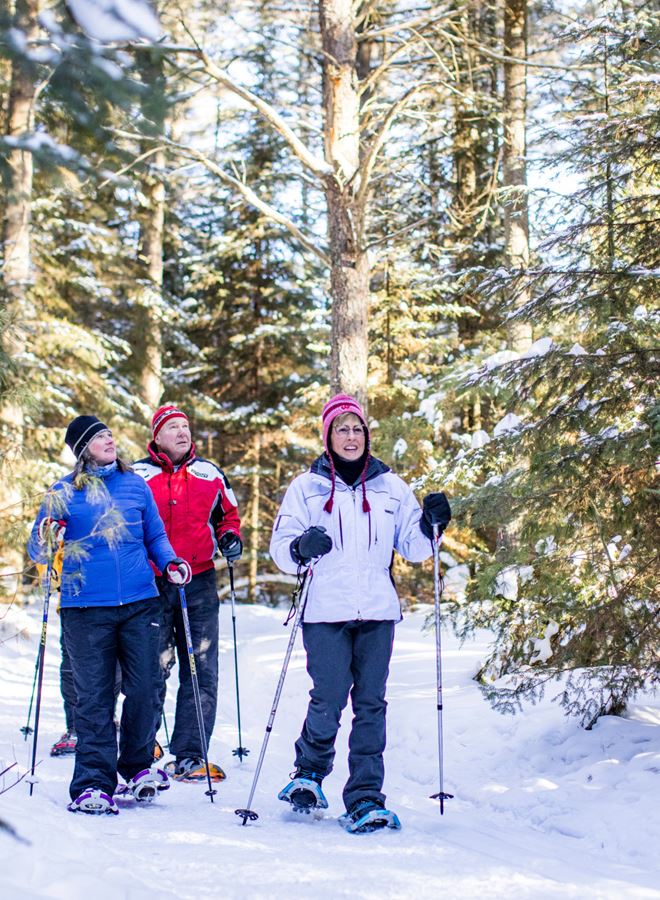 Friends snowshoe the Awassa Trail in St. Germain, Wisconsin