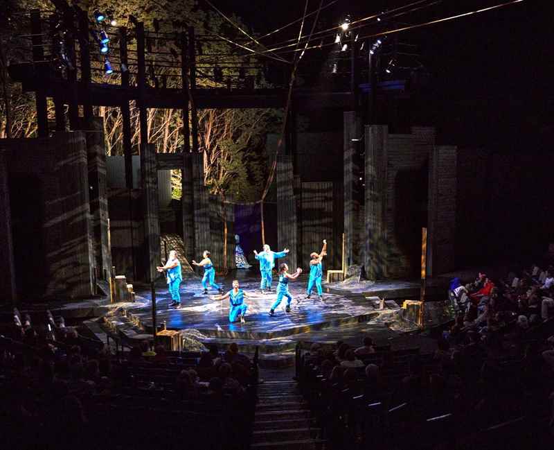 actors perform on an outdoor stage