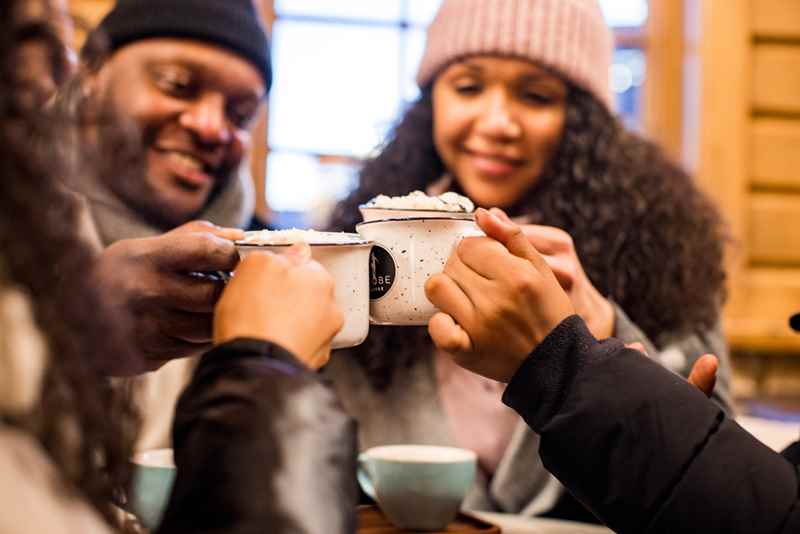 family warms up with cups of hot chocolate