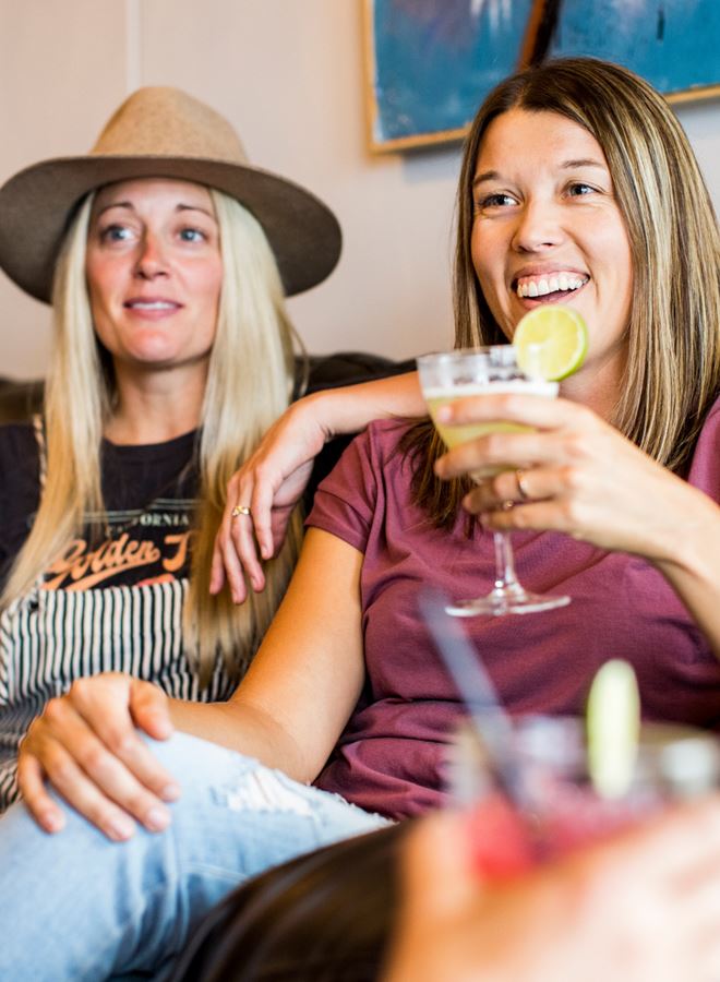 Couple enjoy craft cocktails in the lounge at Lucky Guys Distillery in Hudson, Wisconsin