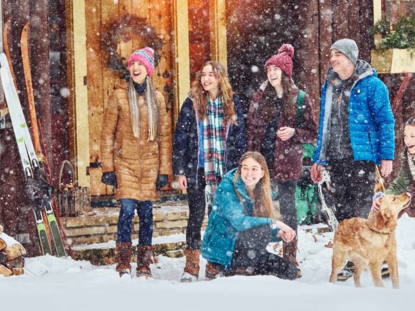 082 Family Watches Snowfall Outside a Cabin